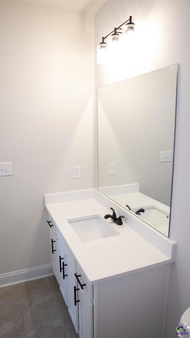 303 Garnet Dr, Bonaire, GA 31005 - bathroom featuring vanity, tile patterned flooring, and baseboards