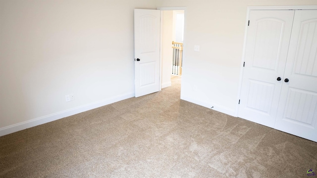 303 Garnet Dr, Bonaire, GA 31005 - unfurnished bedroom featuring carpet floors, baseboards, and a closet