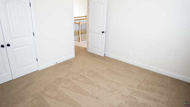 303 Garnet Dr, Bonaire, GA 31005 - unfurnished bedroom with carpet flooring, baseboards, and a closet