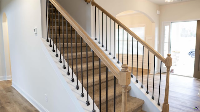 303 Garnet Dr, Bonaire, GA 31005 - stairs featuring arched walkways, wood finished floors, and baseboards