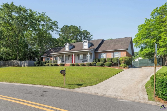 207 Oak Forest Ln, Warner Robins, GA 31088 - cape cod home with covered porch, driveway, and brick siding