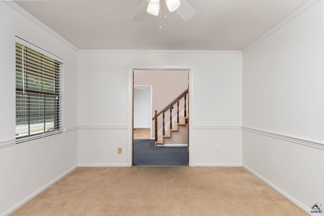 207 Oak Forest Ln, Warner Robins, GA 31088 - carpeted spare room featuring ornamental molding, a textured ceiling, a ceiling fan, stairs, and baseboards
