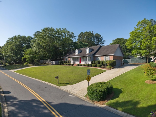207 Oak Forest Ln, Warner Robins, GA 31088 - cape cod house featuring concrete driveway and a garage