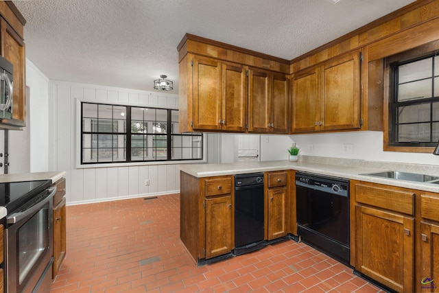 207 Oak Forest Ln, Warner Robins, GA 31088 - kitchen featuring appliances with stainless steel finishes, a sink, brick flooring, light countertops, and a textured ceiling