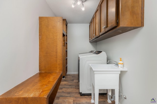 207 Oak Forest Ln, Warner Robins, GA 31088 - laundry area with cabinet space, dark wood-style flooring, washer and clothes dryer, and a textured ceiling