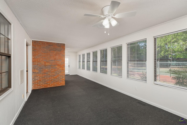 207 Oak Forest Ln, Warner Robins, GA 31088 - unfurnished sunroom with carpet flooring, a textured ceiling, baseboards, and brick wall