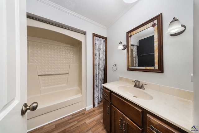 207 Oak Forest Ln, Warner Robins, GA 31088 - full bathroom featuring crown molding, vanity, wood finished floors, shower / bath combo, and a textured ceiling