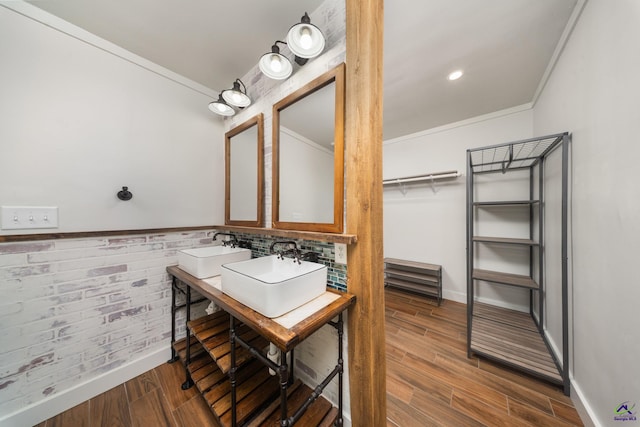 207 Oak Forest Ln, Warner Robins, GA 31088 - bathroom with crown molding, wood finished floors, double vanity, and baseboards