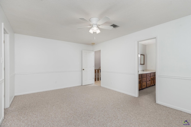 207 Oak Forest Ln, Warner Robins, GA 31088 - unfurnished bedroom featuring light carpet, baseboards, a sink, and a textured ceiling
