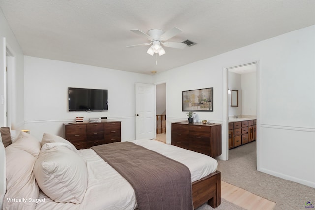 207 Oak Forest Ln, Warner Robins, GA 31088 - bedroom with light carpet, a ceiling fan, a sink, and ensuite bathroom