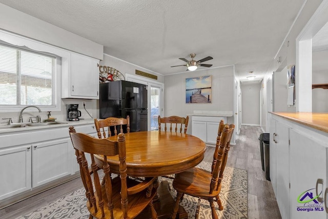 1322 Melford Dr, Columbus, GA 31907 - dining area with light wood-type flooring, a ceiling fan, and a textured ceiling