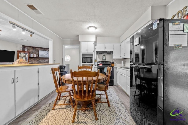 1322 Melford Dr, Columbus, GA 31907 - dining space with light wood-type flooring and a textured ceiling