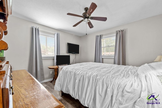 1322 Melford Dr, Columbus, GA 31907 - bedroom with dark wood-style flooring, a ceiling fan, and baseboards