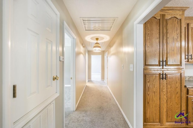 4407 Jones Rds, Macon, GA 31216 - hallway featuring carpet flooring, baseboards, and attic access