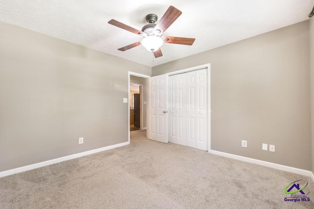 4407 Jones Rds, Macon, GA 31216 - unfurnished bedroom featuring carpet, baseboards, a closet, and a ceiling fan