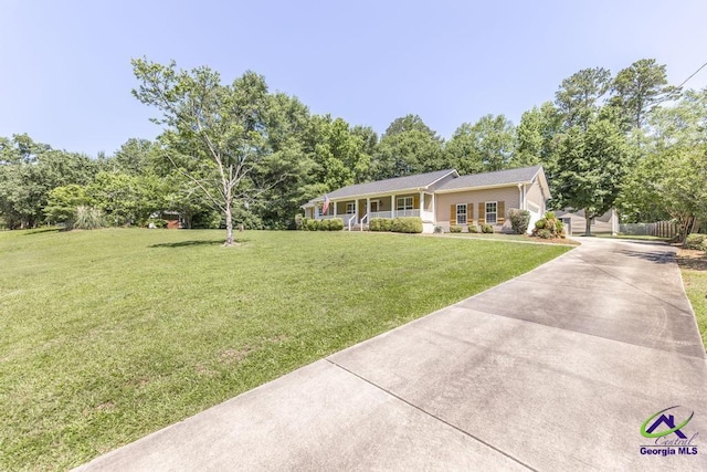 4407 Jones Rds, Macon, GA 31216 - single story home with driveway, a front yard, and a porch