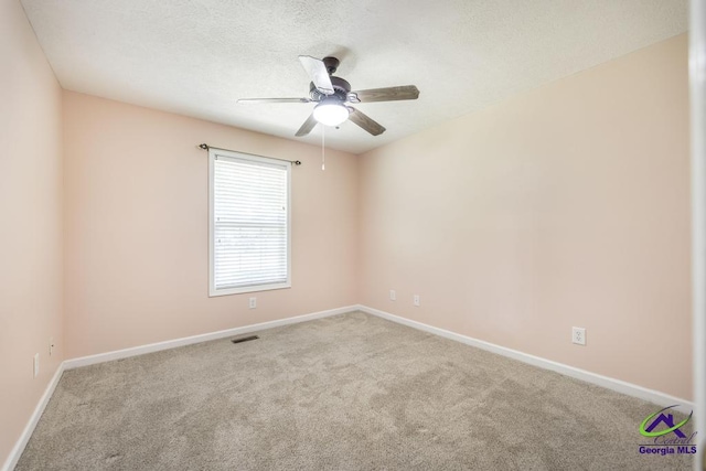 4407 Jones Rds, Macon, GA 31216 - empty room with carpet, ceiling fan, baseboards, and a textured ceiling