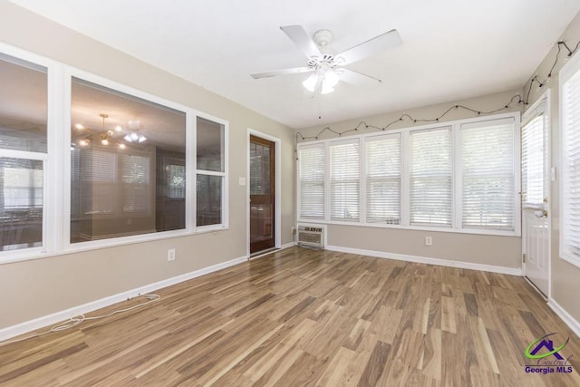 4407 Jones Rds, Macon, GA 31216 - unfurnished sunroom featuring wood finished floors, plenty of natural light, and baseboards