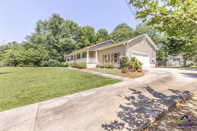 4407 Jones Rds, Macon, GA 31216 - single story home featuring a porch, a front yard, an attached garage, and concrete driveway