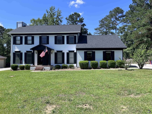 757 Silver Springs Drs, Macon, GA 31210 - colonial inspired home with a chimney, a front yard, and a shingled roof