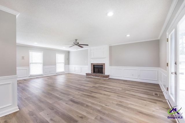 757 Silver Springs Drs, Macon, GA 31210 - unfurnished living room featuring ceiling fan, ornamental molding, a decorative wall, wainscoting, and recessed lighting