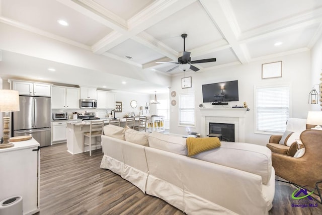 601 Hunts Landing Dr, Kathleen, GA 31047 - living area with a ceiling fan, beamed ceiling, dark wood finished floors, a glass covered fireplace, and healthy amount of natural light