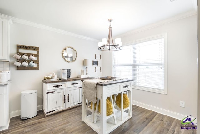 601 Hunts Landing Dr, Kathleen, GA 31047 - dining space with ornamental molding, baseboards, a chandelier, and wood finished floors