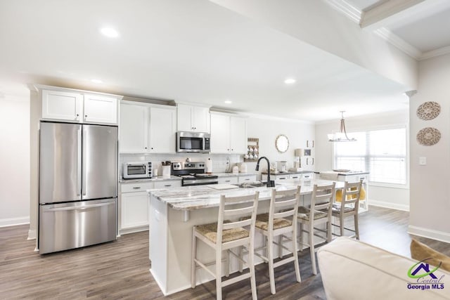 601 Hunts Landing Dr, Kathleen, GA 31047 - kitchen with stainless steel appliances, ornamental molding, white cabinets, dark wood finished floors, and recessed lighting