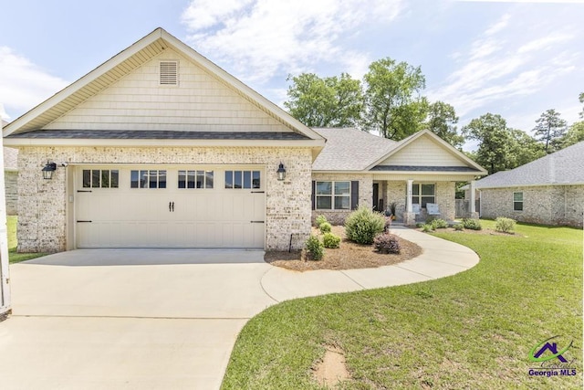 601 Hunts Landing Dr, Kathleen, GA 31047 - view of front of house with a front lawn, concrete driveway, a garage, brick siding, and roof with shingles