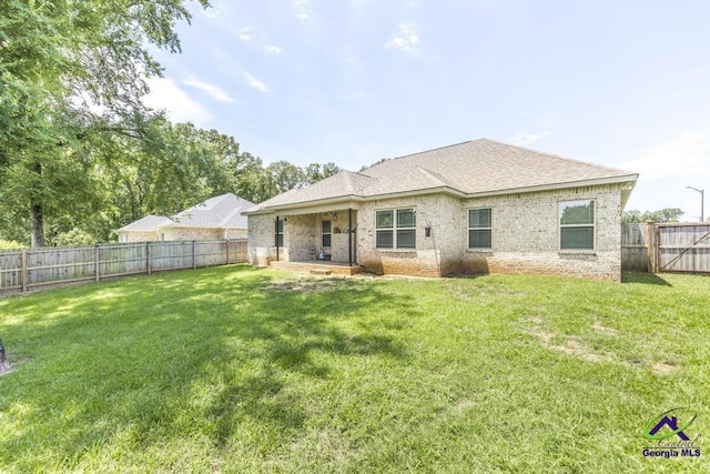 601 Hunts Landing Dr, Kathleen, GA 31047 - rear view of property featuring brick siding and roof with shingles