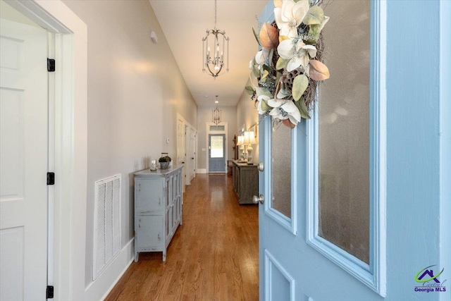 1360 Calhoun St, Macon, GA 31201 - hall featuring a chandelier and wood finished floors