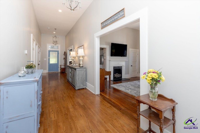 1360 Calhoun St, Macon, GA 31201 - foyer featuring light wood-type flooring, a chandelier, a fireplace with raised hearth, recessed lighting, and baseboards