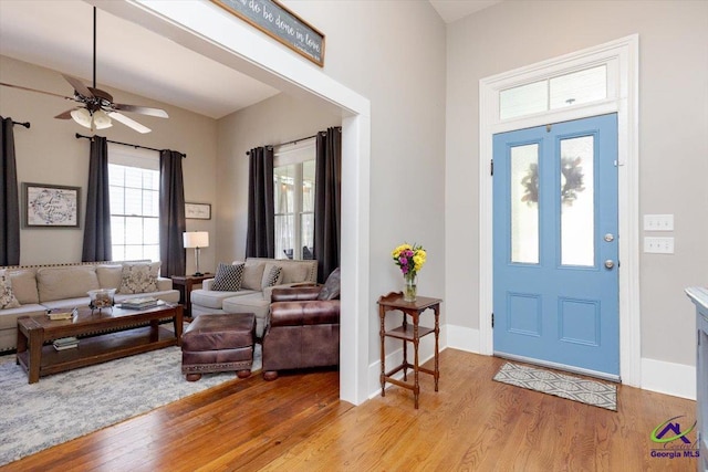 1360 Calhoun St, Macon, GA 31201 - foyer with light wood finished floors, a ceiling fan, and baseboards