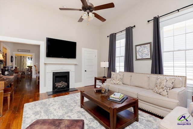 1360 Calhoun St, Macon, GA 31201 - living area featuring a ceiling fan, wood finished floors, and a fireplace with flush hearth