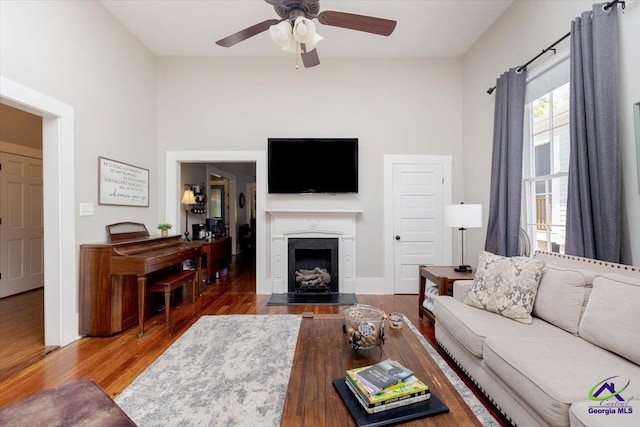 1360 Calhoun St, Macon, GA 31201 - living area with a ceiling fan, wood finished floors, and a fireplace with flush hearth