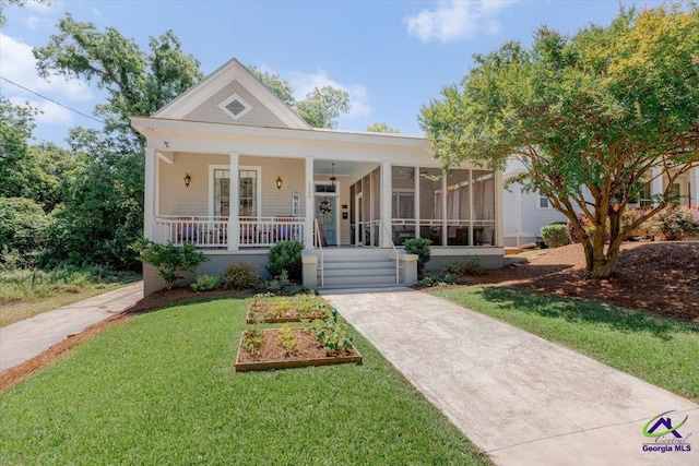 1360 Calhoun St, Macon, GA 31201 - view of front of house featuring a front lawn, a porch, and a sunroom