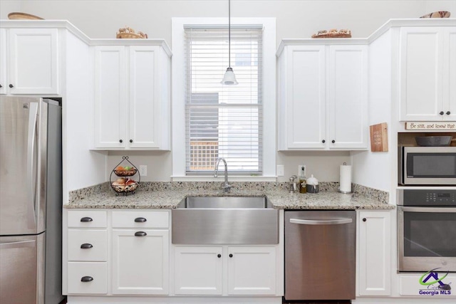 1360 Calhoun St, Macon, GA 31201 - kitchen featuring appliances with stainless steel finishes, a sink, and white cabinetry
