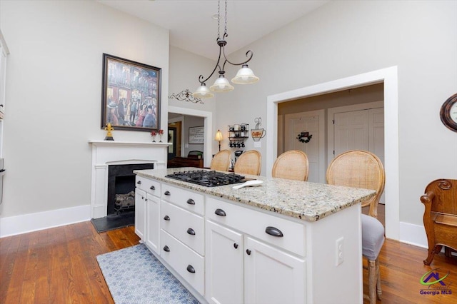 1360 Calhoun St, Macon, GA 31201 - kitchen with white cabinets, dark wood-style flooring, and a center island