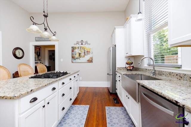 1360 Calhoun St, Macon, GA 31201 - kitchen featuring stainless steel appliances, a sink, dark wood-style flooring, and white cabinetry