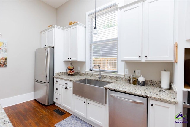 1360 Calhoun St, Macon, GA 31201 - kitchen with appliances with stainless steel finishes, a sink, dark wood-style flooring, and white cabinets