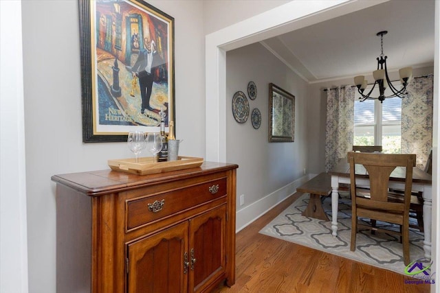 1360 Calhoun St, Macon, GA 31201 - dining space with a chandelier, light wood-style flooring, and baseboards