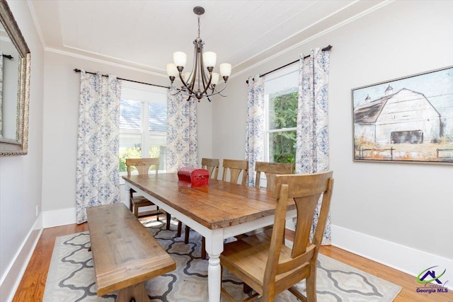 1360 Calhoun St, Macon, GA 31201 - dining space with ornamental molding, a chandelier, healthy amount of natural light, wood finished floors, and baseboards