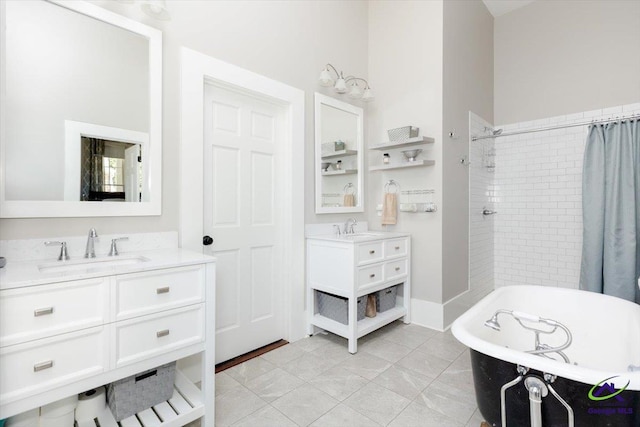 1360 Calhoun St, Macon, GA 31201 - bathroom featuring a soaking tub, two vanities, a tile shower, and tile patterned flooring