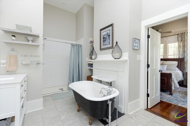 1360 Calhoun St, Macon, GA 31201 - full bathroom with tiled shower, ensuite bathroom, a freestanding bath, tile patterned floors, and vanity