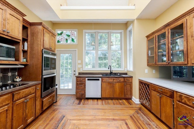 283 Limestone Rd, Cochran, GA 31014 - kitchen featuring stainless steel appliances, a sink, brown cabinets, and healthy amount of natural light