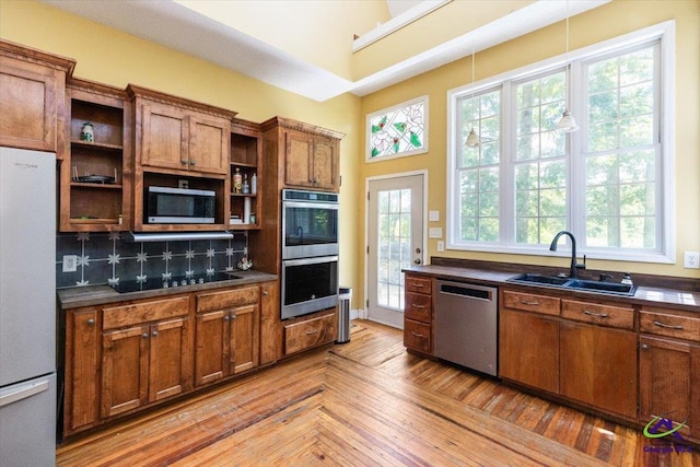 283 Limestone Rd, Cochran, GA 31014 - kitchen featuring open shelves, stainless steel appliances, a sink, brown cabinets, and dark countertops