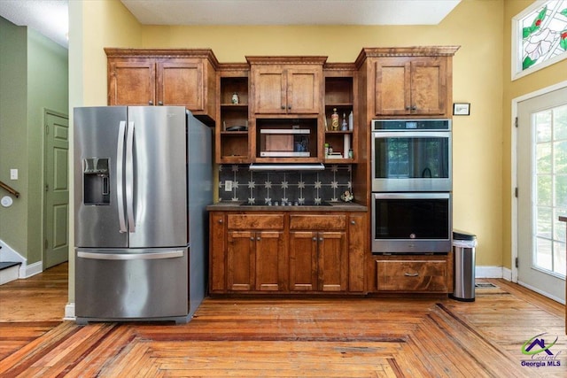 283 Limestone Rd, Cochran, GA 31014 - kitchen featuring stainless steel appliances, open shelves, brown cabinets, backsplash, and baseboards