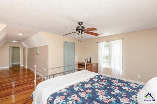 283 Limestone Rd, Cochran, GA 31014 - bedroom featuring baseboards, a textured ceiling, wood finished floors, vaulted ceiling, and a ceiling fan