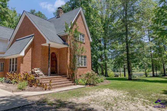 283 Limestone Rd, Cochran, GA 31014 - traditional-style home with brick siding, a front lawn, a chimney, and roof with shingles