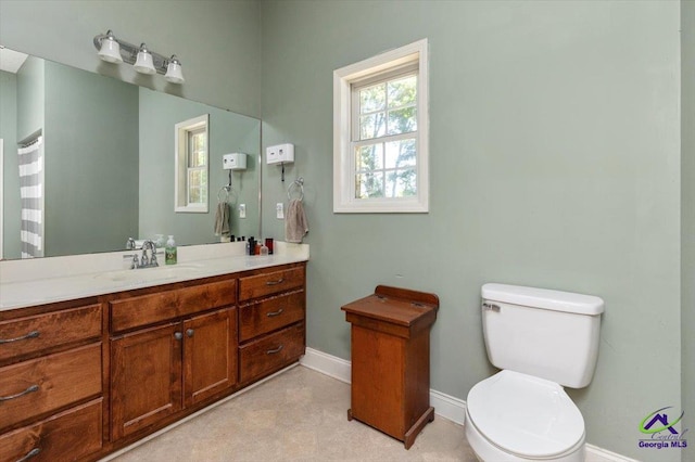 283 Limestone Rd, Cochran, GA 31014 - bathroom with baseboards, toilet, and vanity